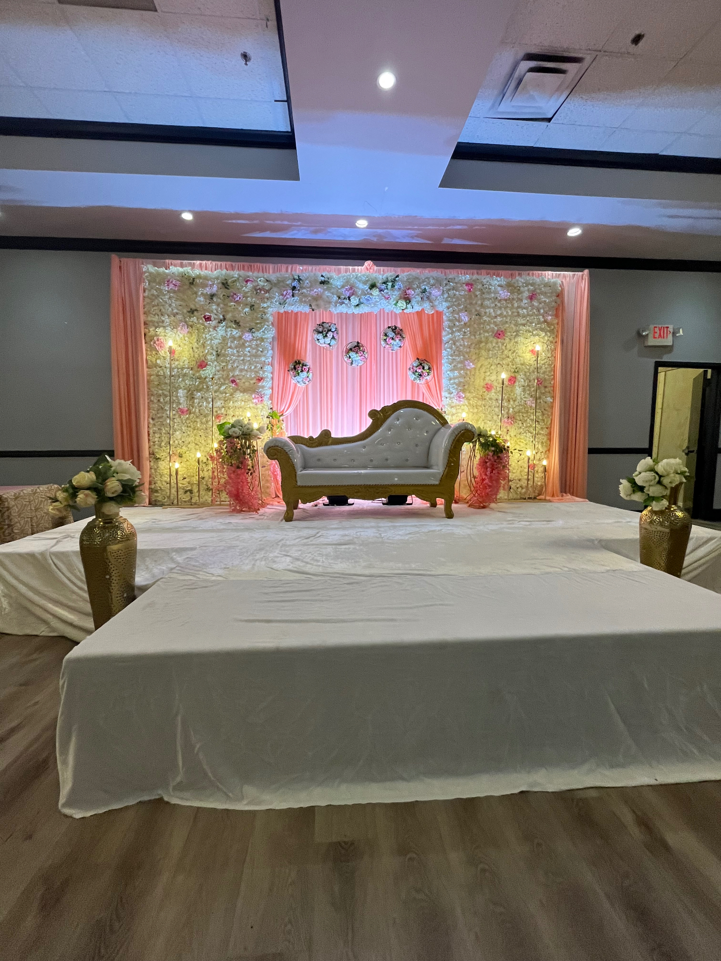 Blush floral party backdrop with chaise lounge