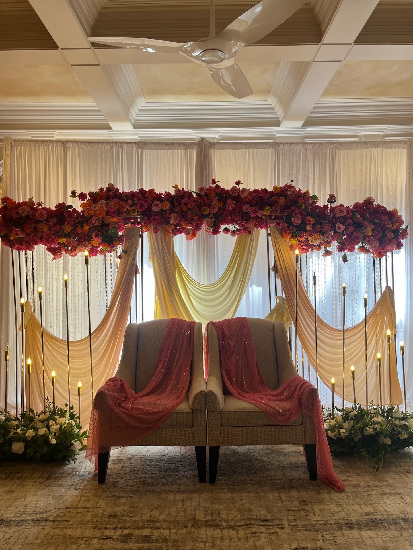 Red floral party canopy with yellow draping