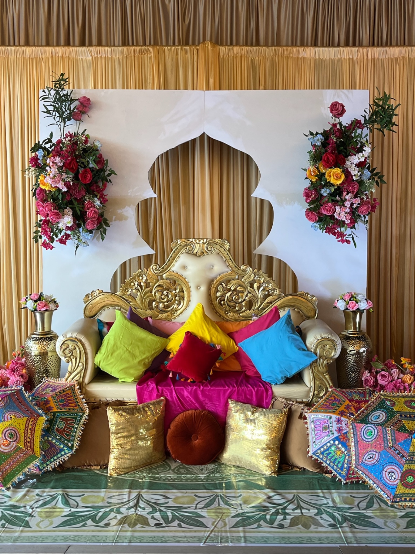 Gold Haldi sofa with colourful pillows