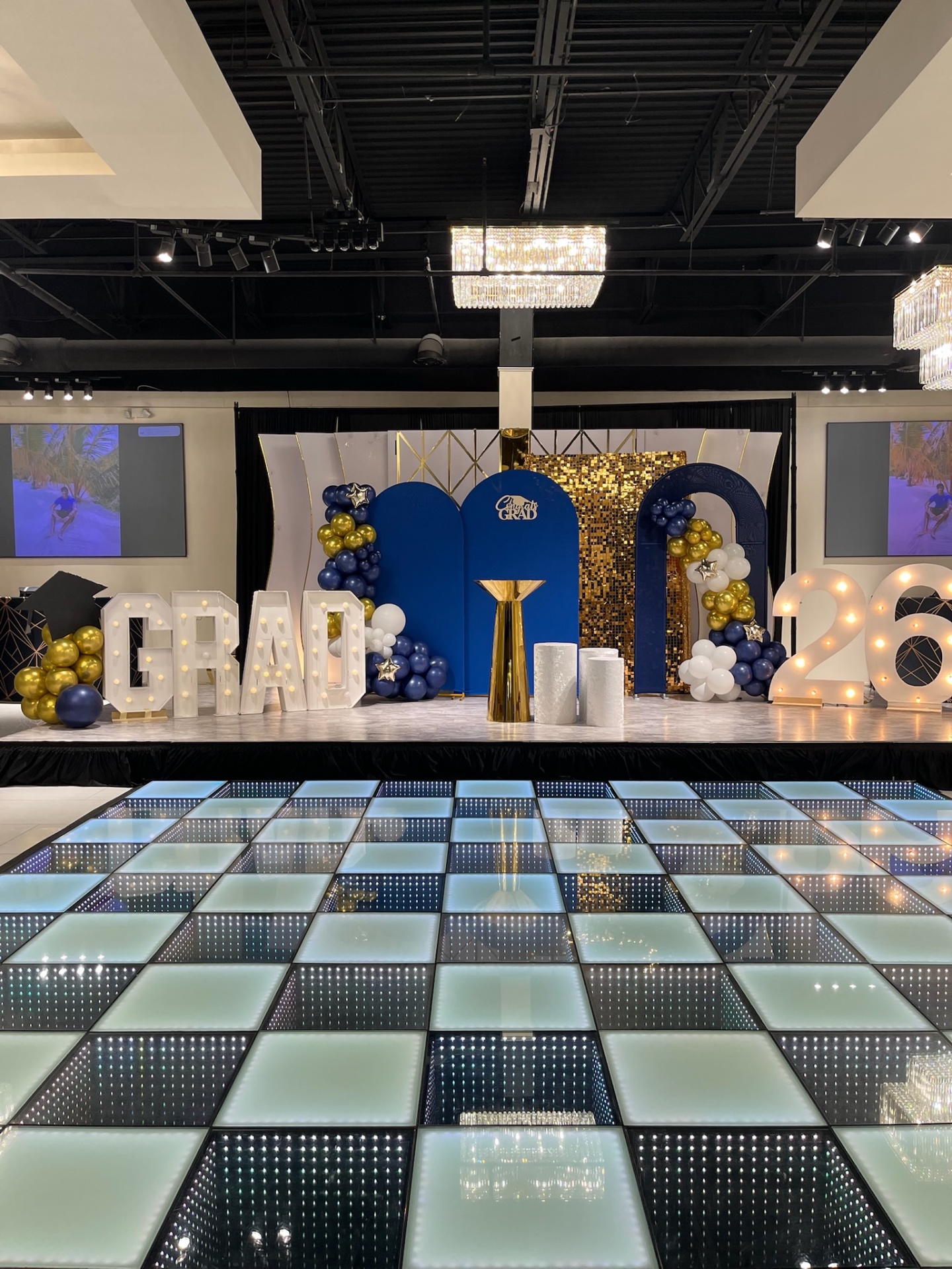 Blue and gold graduation party stage with illuminated dance floor