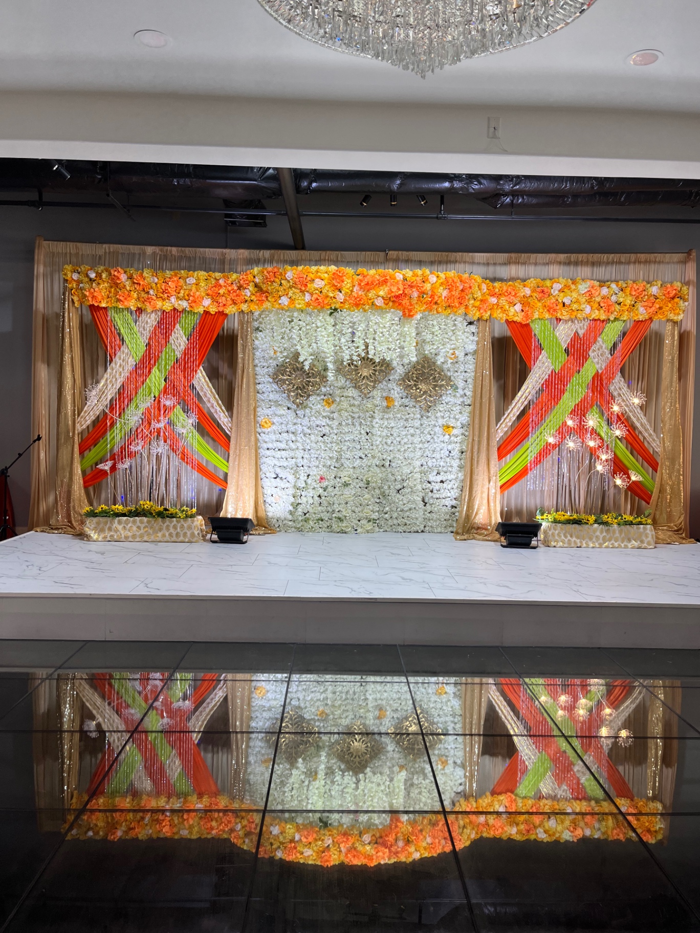 Orange and green draped celebration stage