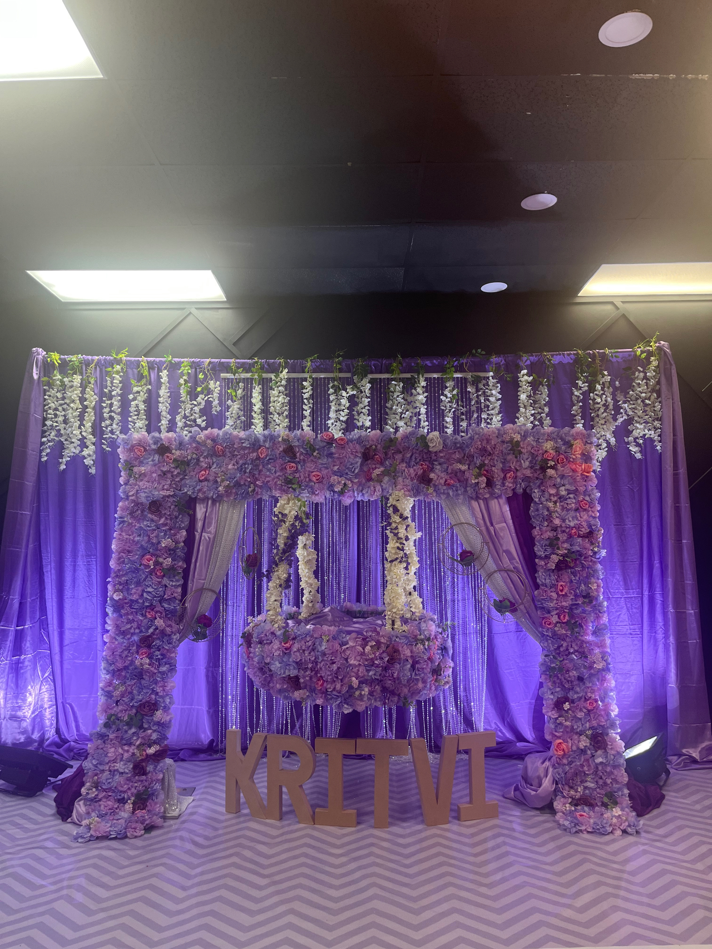 Purple floral swing setting for a special occasion