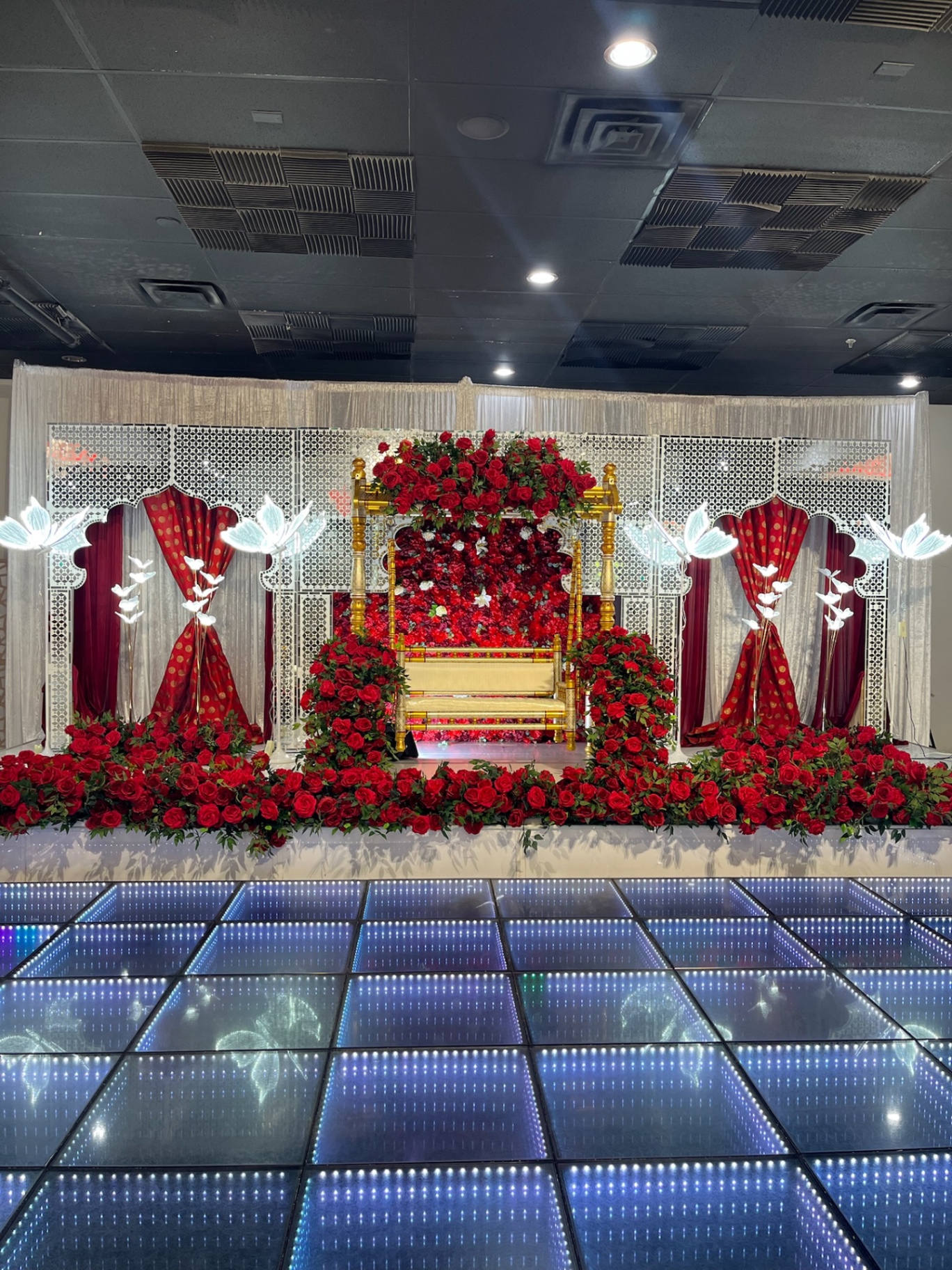 Red rose ceremonial swing with illuminated lotus details