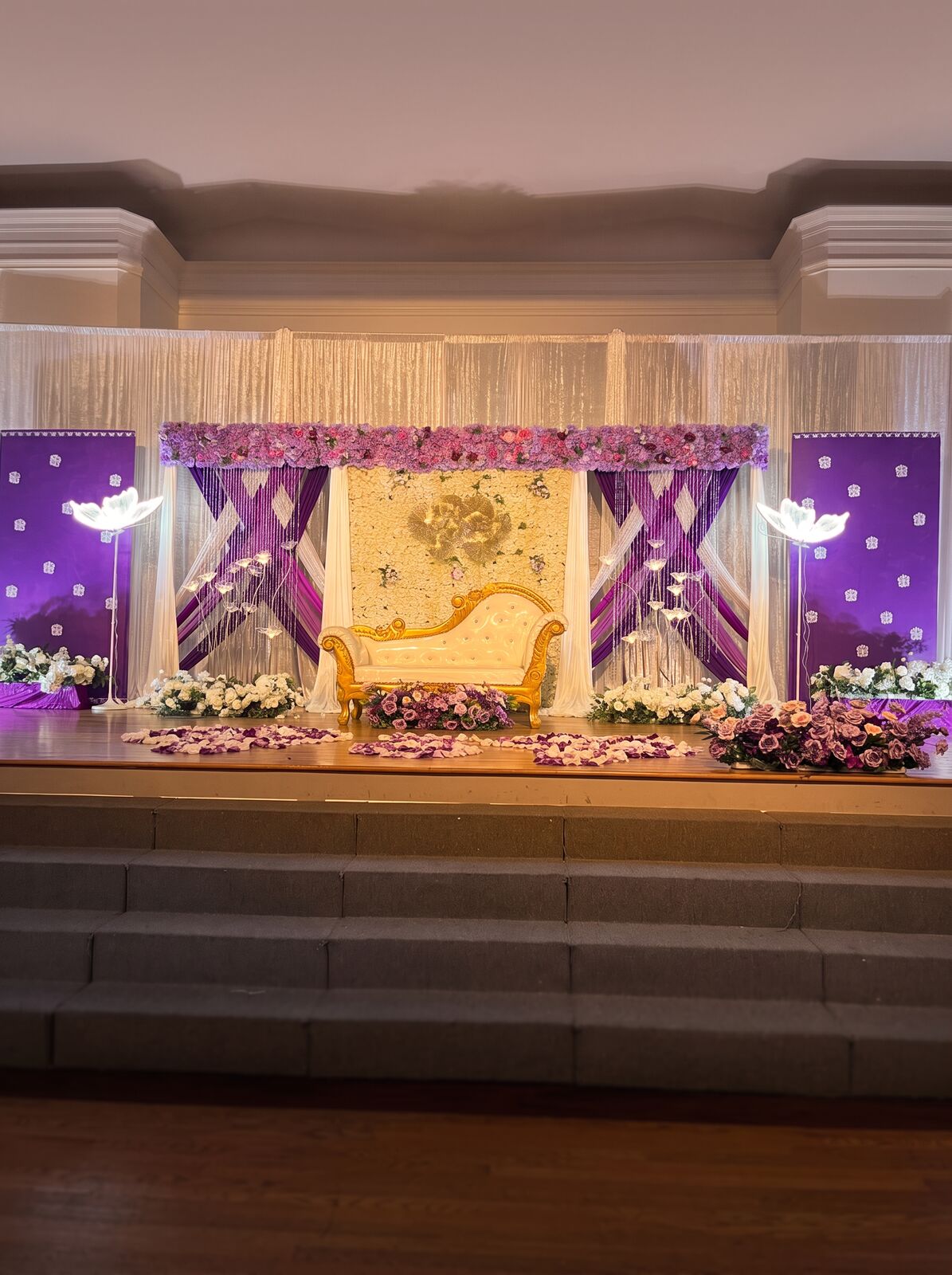 Elegant engagement stage with red florals