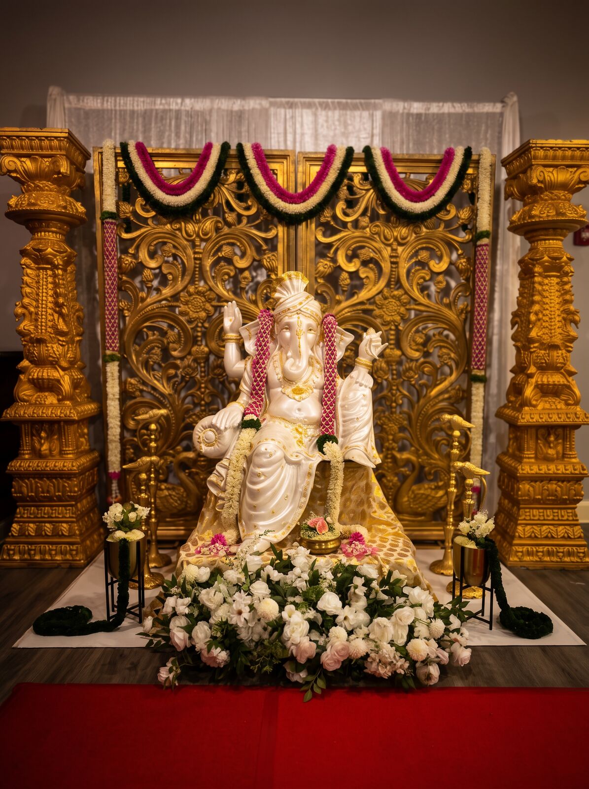 Ganapati entrance arrangement with florals and candles
