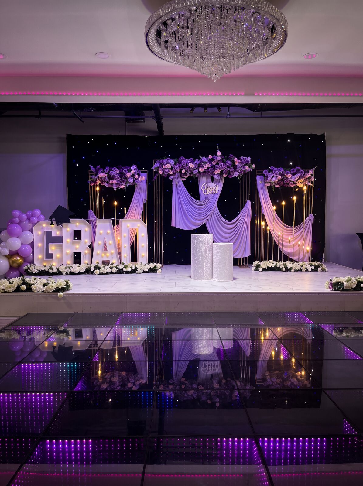Graduation stage with lilac floral canopy