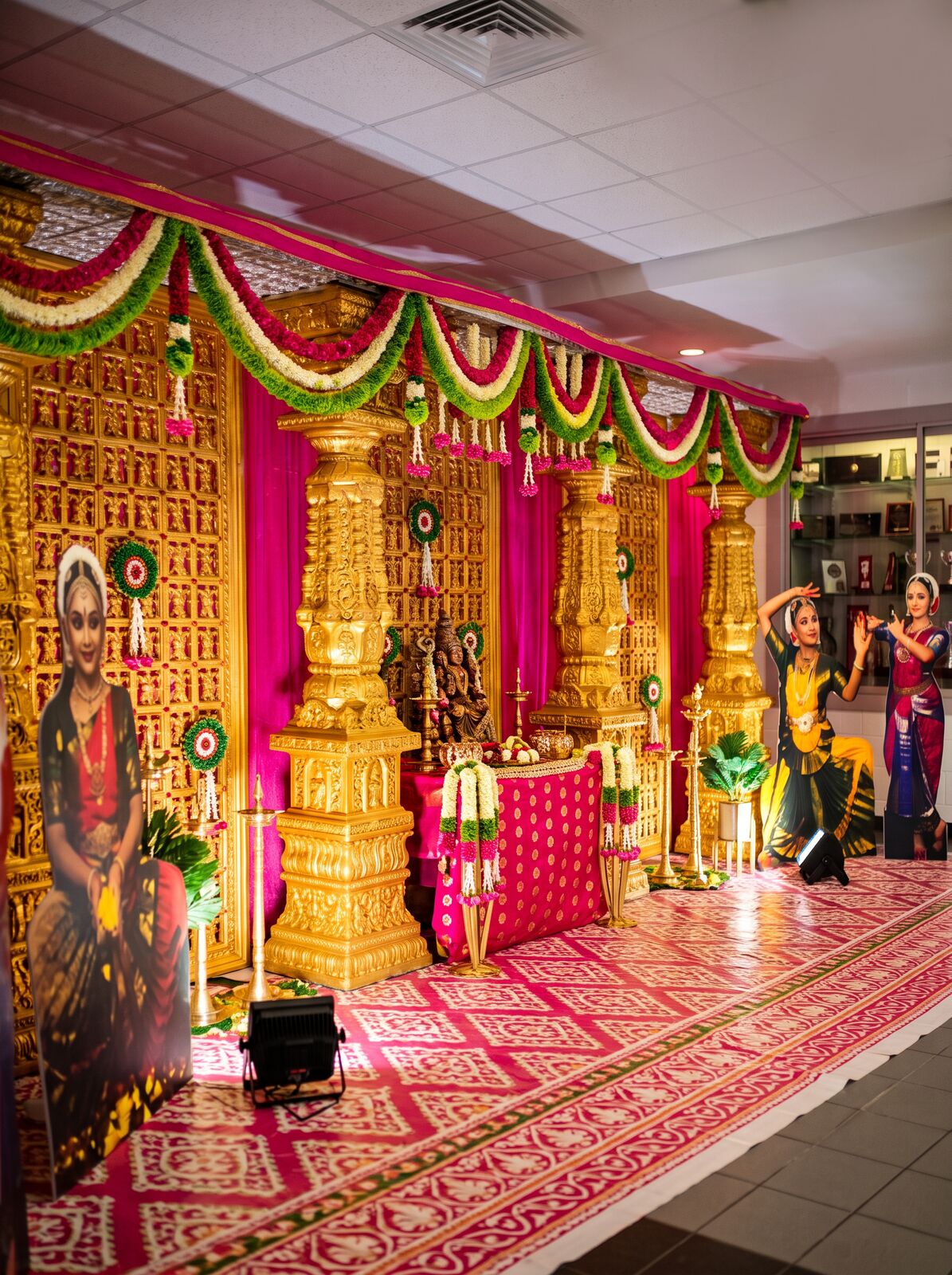 Pink and gold cultural stage with temple panels