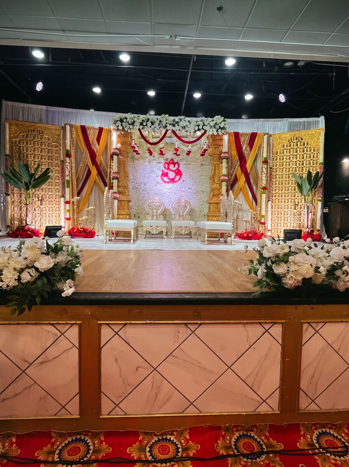 Gold and white carved wedding stage