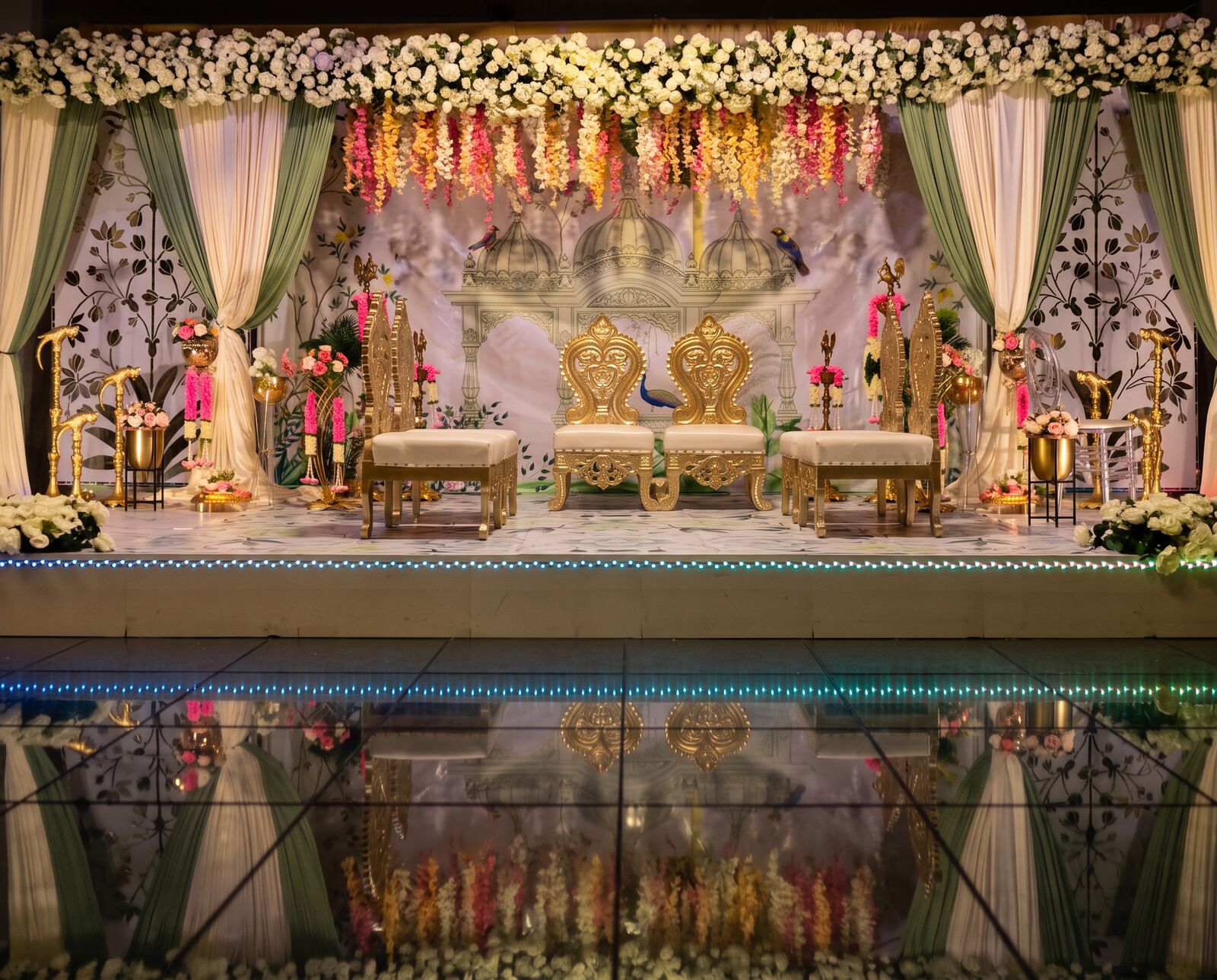 Sage and ivory mandap with hanging pastel flowers